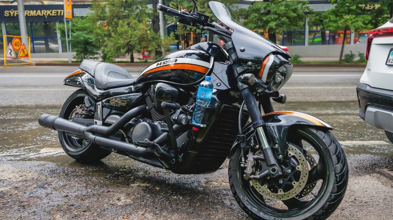 A black Suzuki M109R Boulevard cruiser bike parked on pavement on its kickstand.