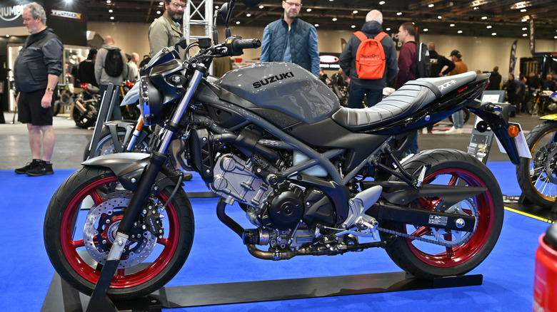 A red and black Suzuki SV650 motorbike on display at the 2025 MCN Motor Show in London.