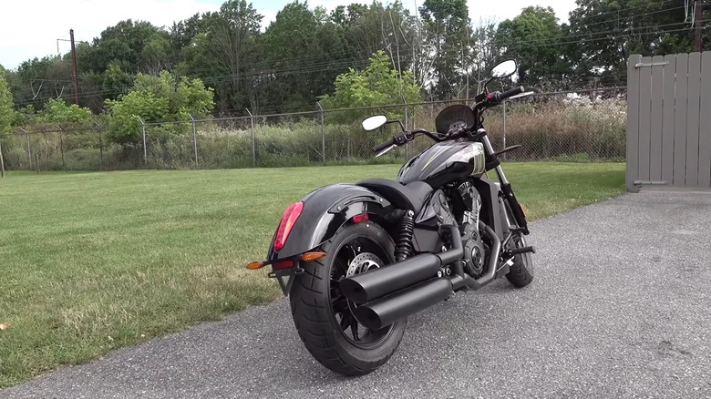 A black Victory Octane performance cruiser motorbike parked at the side of a paved road.