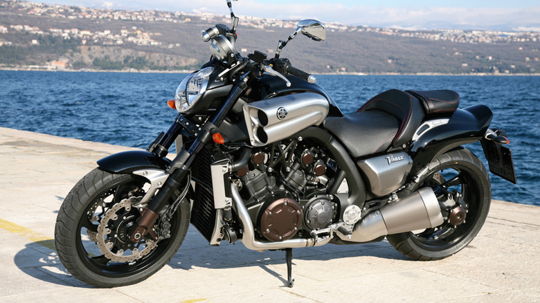 A black and chrome Yamaha VMax from the early 2000s photographed next to water.