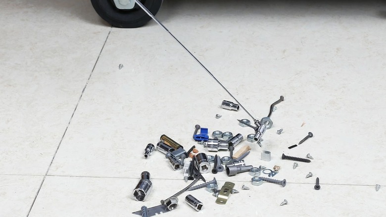 Person picking up hardware with magnetic pick-up tool