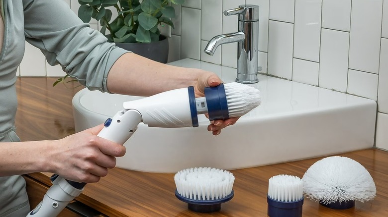 Person using Casabella power spin scrubber