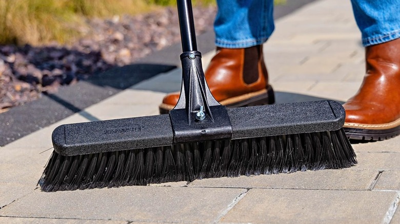 Person holding Libman push broom