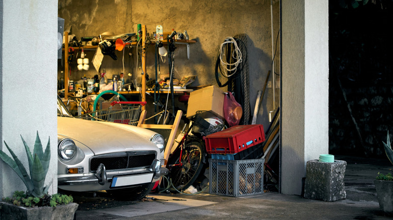 Car parked in messy garage