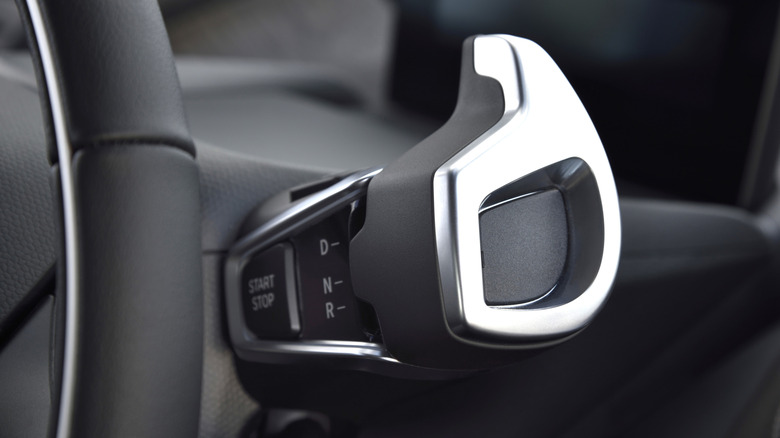Close-up of the BMW i3's column shifter mounted behind the steering wheel.