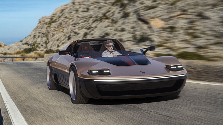 A man in sunglasses driving along a winding mountain road in a brown Bertone Runabout with pop-up headlights.