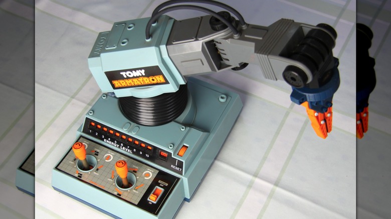 A TOMY Armatron toy robot with accessories