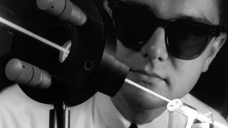 A man observing a laser beam in 1964