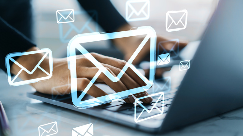 A person typing on laptop with glowing email icons overlaid