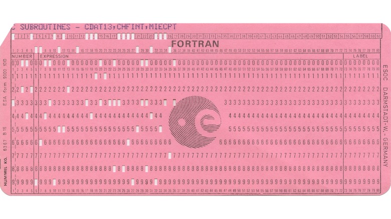 A pink FORTRAN punch card against a white background