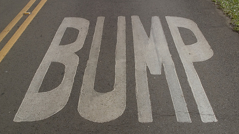 bump warning painted on road