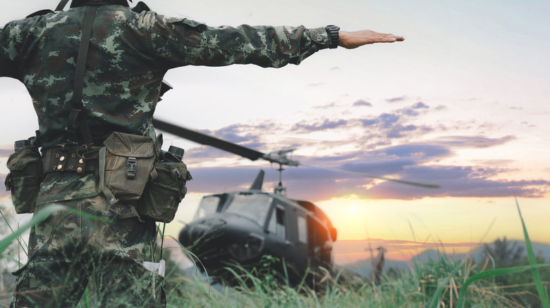 Soldier signaling to military helicopter