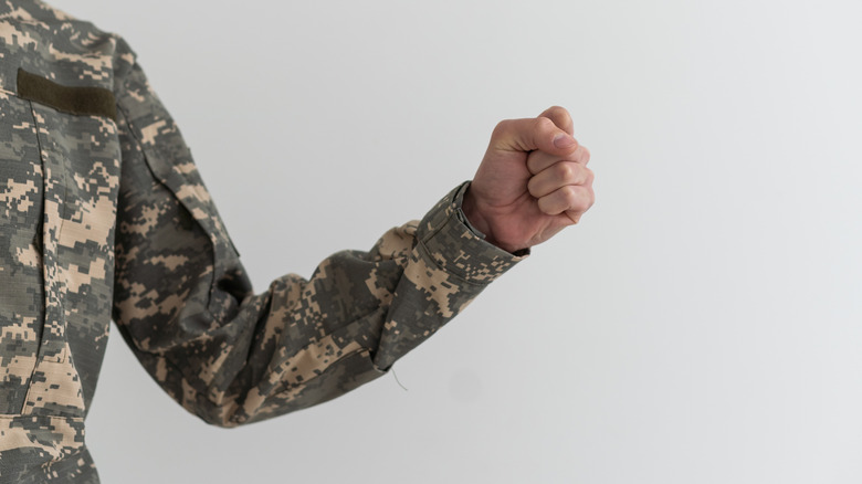Hand making military freeze gesture