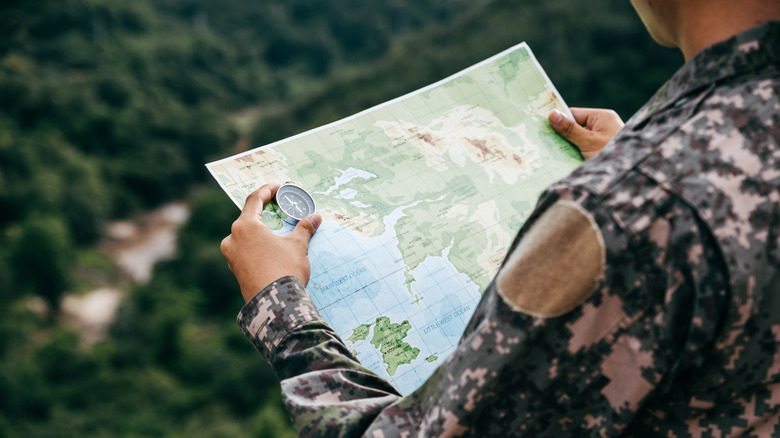 soldier checks map