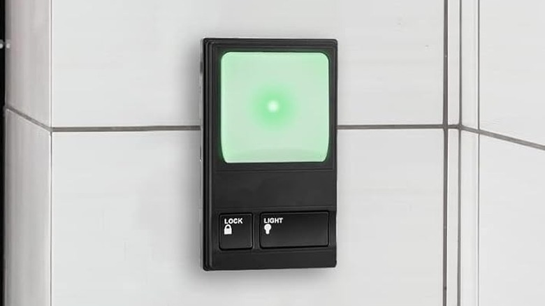 Garage door switch with a lock and light button.