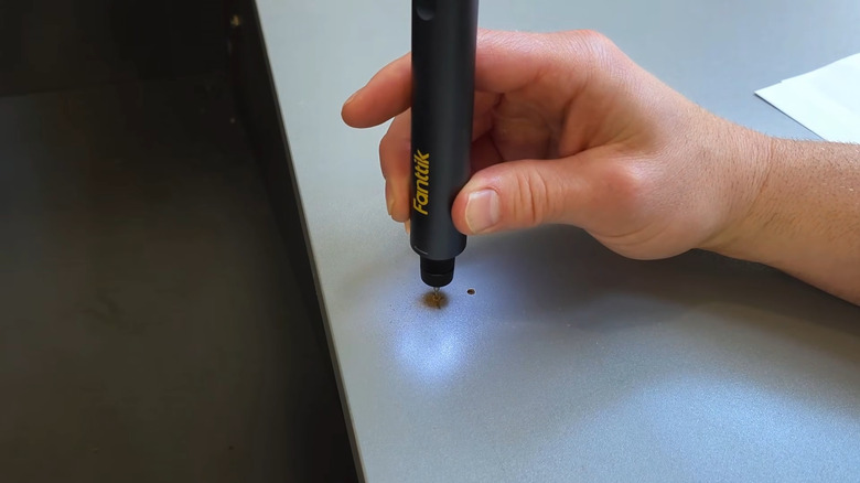 A close up of the Fanttik rotary tool kit in use