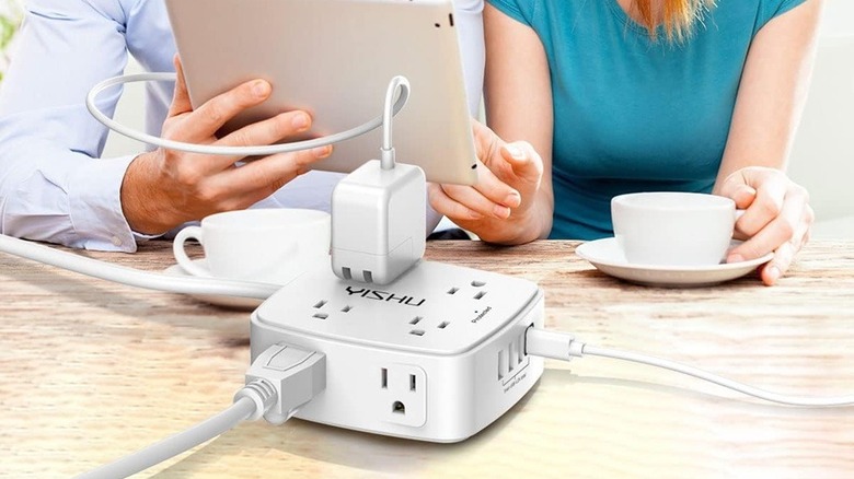 Two people using power strip
