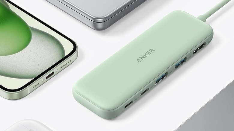 USB hub next to phone, laptop, and other devices