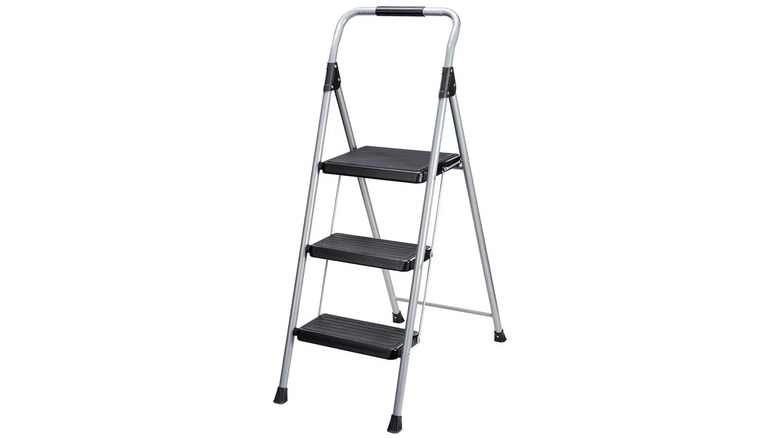 A three-step stepladder with black steps and silver bars.