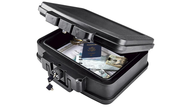A black fire-resistant and waterproof safe with various documents inside.