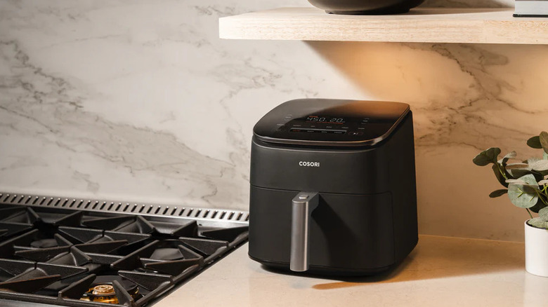 A black Cosori Air Fryer on a kitchen counter