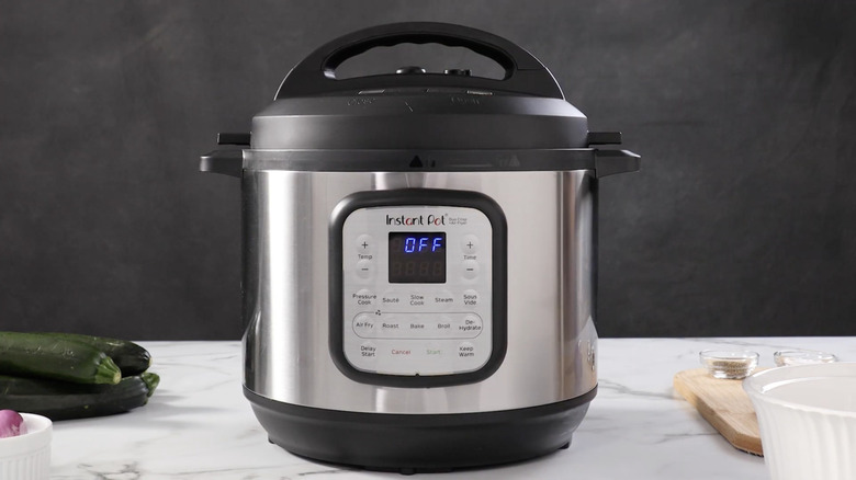 An Instant Pot resting on a granite kitchen counter