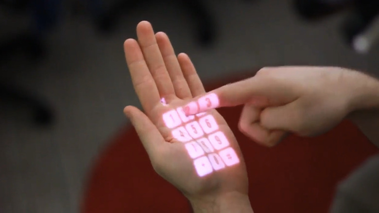 A person's hand with a calculator projected onto it by the OmniTouch projector.