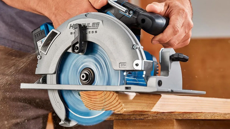 A Hercules handheld circular saw cutting wood.
