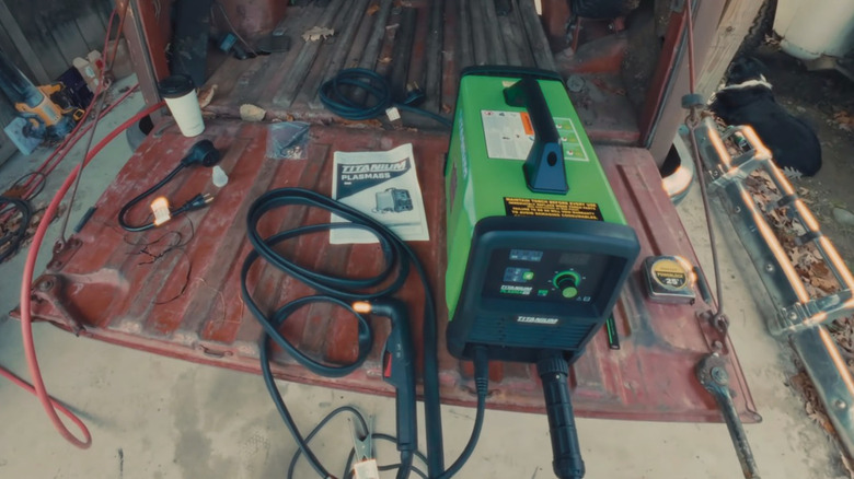 A Titanium 65 amp plasma cutter on a pickup truck tailgate.