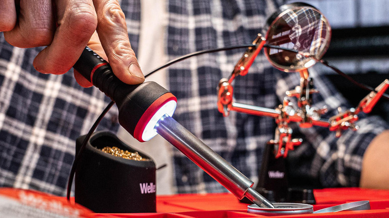 A man using a soldering iron.