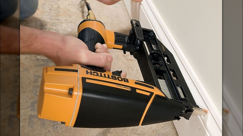 securing baseboard with Bostitch nailer