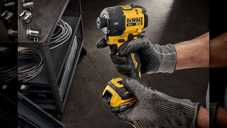 Man holding DeWalt hydraulic impact driver