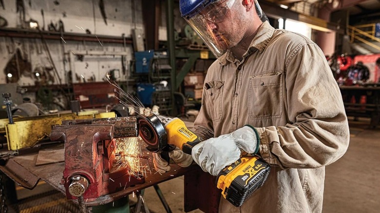 Man using angle grinder on a metal object
