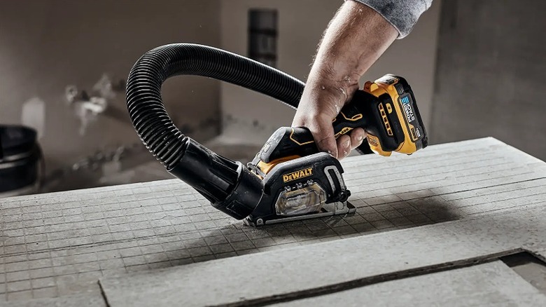 Using cut off tool on a piece of tile