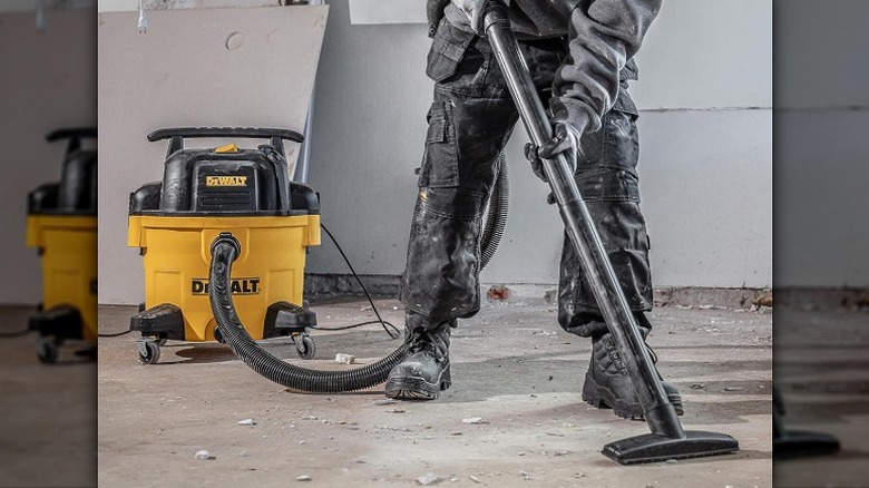 Using DeWalt vacuum to clean up a messy work area