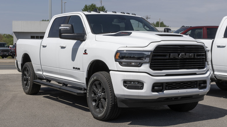 A Dodge RAM 3500 in white, Big Horn trim, parked in a dealer lot.