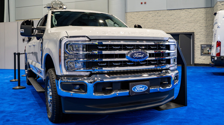 A silver Ford Supr Duty F 350 on display at a stand at an indoor motor show