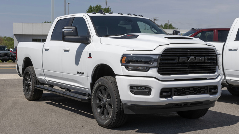 A white 2024 RAM 3500 heavy duty Laramie pickup truck parked at the side of a lot