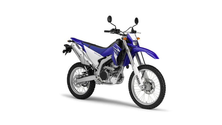 A blue and white Yamaha WR250R standing on a white background.