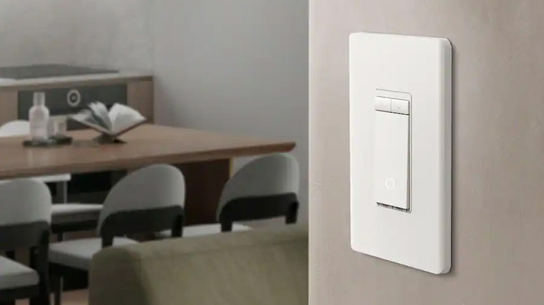 A TP-Link brand smart light switch on a wall.