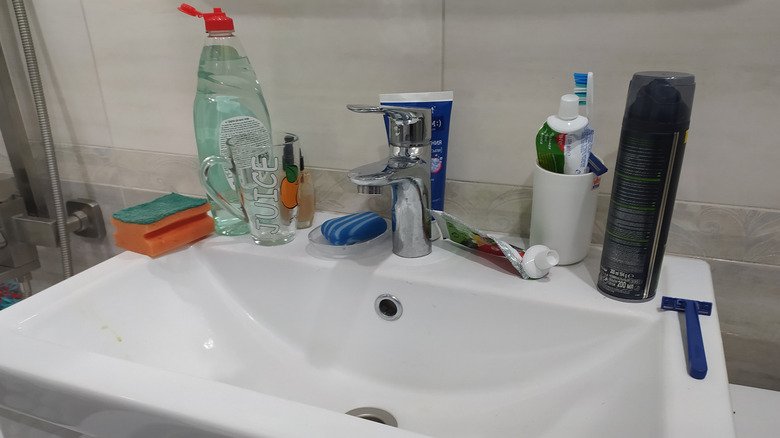 A bathroom sink with multiple bathroom items
