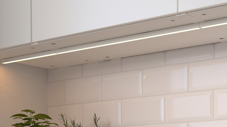 The underside of a cabinet with an LED strip