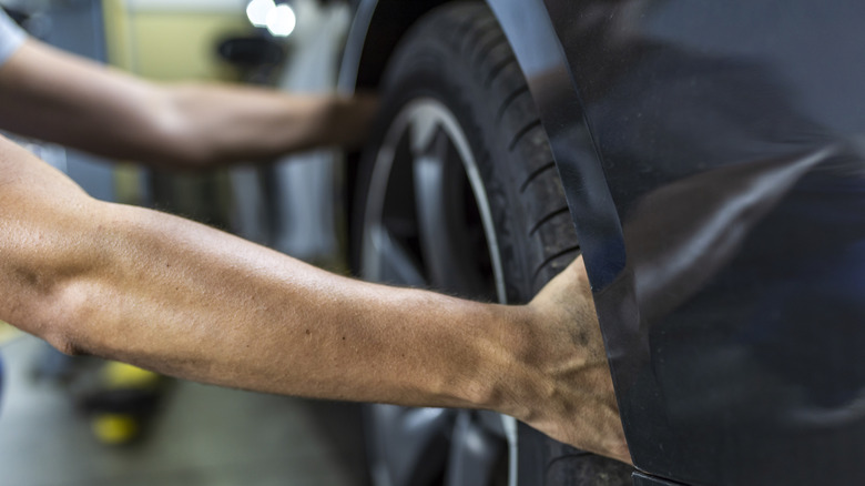 A person changing a tire