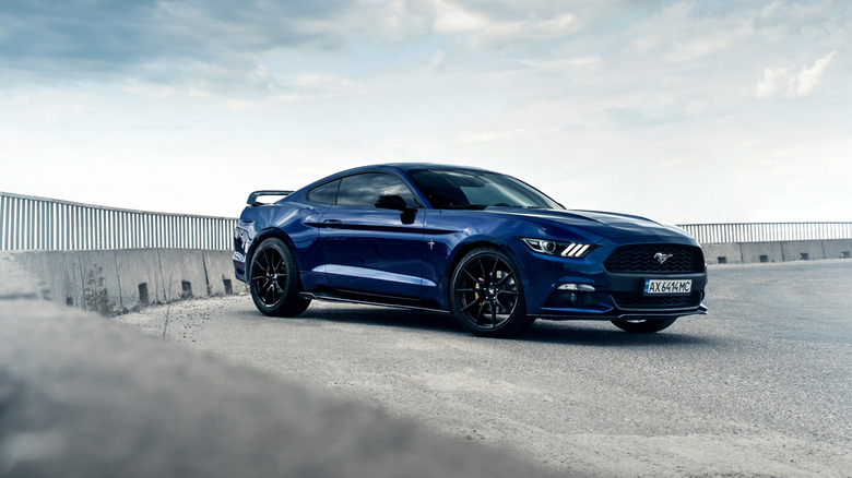 An ultramarine Ford Mustang on a gravel track