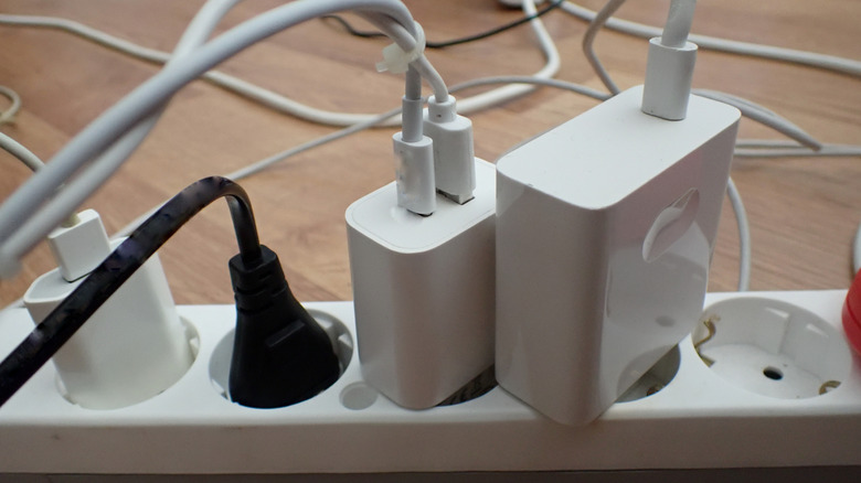 An overladed power strip with multiple devices plugged in