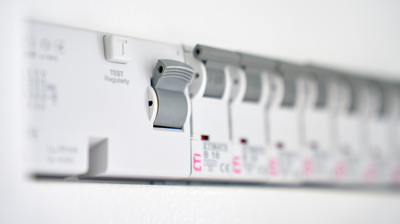 A bunch of surge protectors installed on a wall