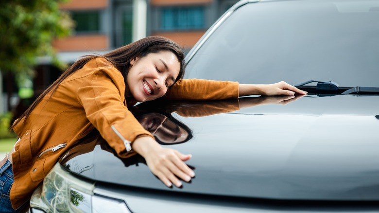 Woman hugging her car