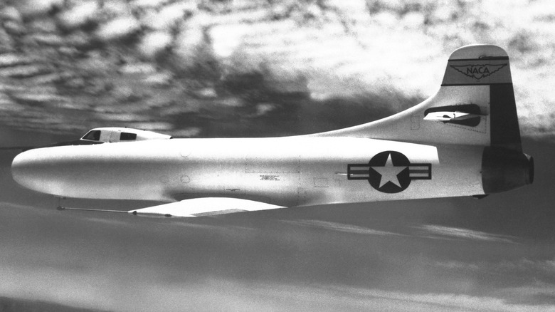 The Douglas D-558-I Skystreak flying beneath the clouds at high speed