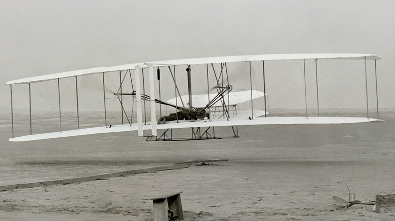 The first successful flight of the Wright Flyer in 1903 with Orville Wright at the controls