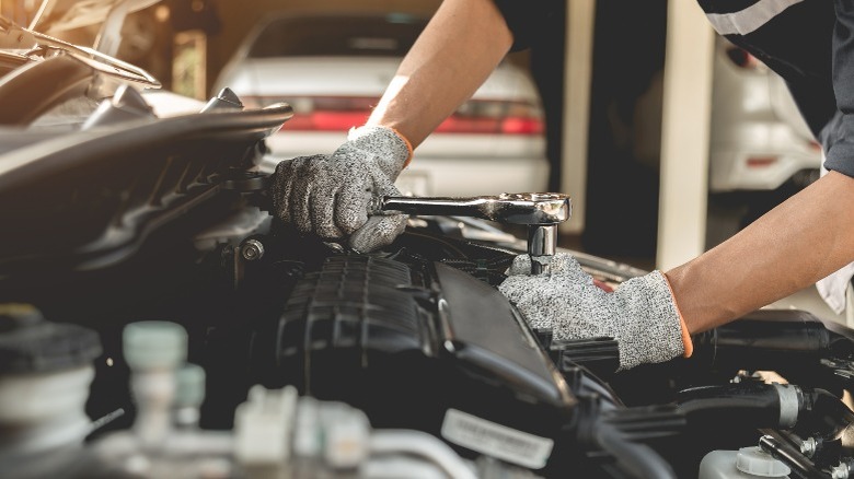 mechanic repairing a car engine
